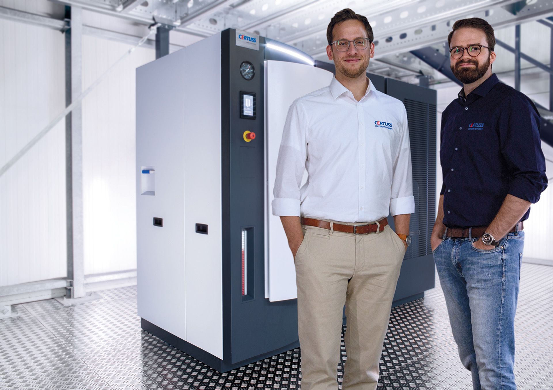 2 people in front of an electric steam generator